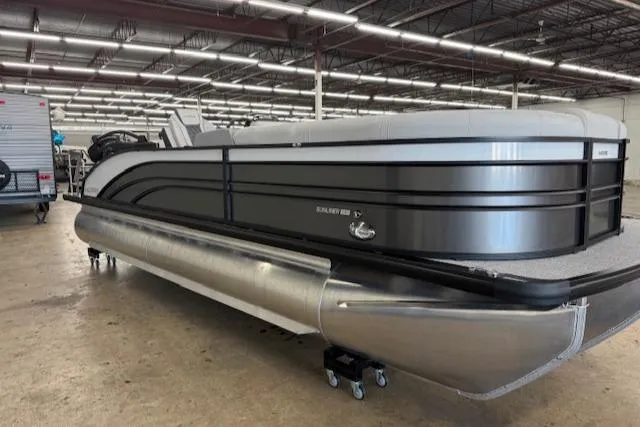 Slide: The Image of 2025 Harris Sunliner 230 pontoon boat in a showroom, showcasing sleek design and modern features. - 4