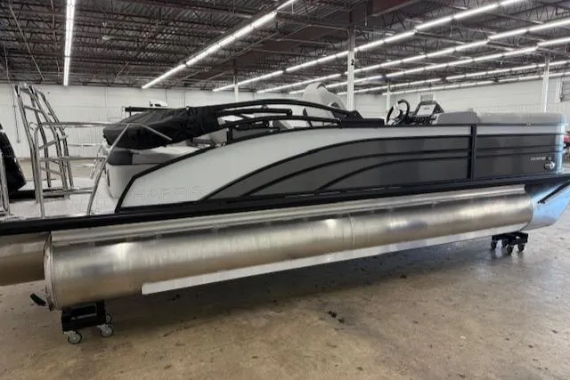 Slide: The Image of 2025 Harris Sunliner 230 pontoon boat in a warehouse setting. - 5