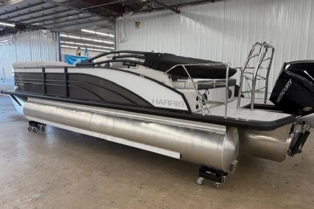 Slide: The Image of 2025 Harris Sunliner 230 pontoon boat in a warehouse setting. - 9