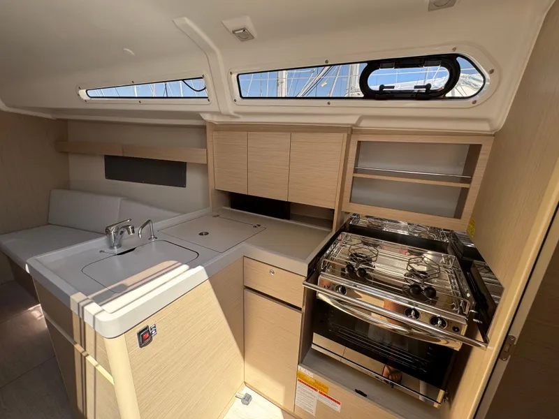 Slide: The Image of 2024 Beneteau Oceanis 34.1 yacht interior with modern kitchen and seating area. - 10