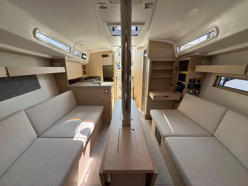 Slide: The Image of 2024 Beneteau Oceanis 34.1 interior with modern design, spacious seating, and natural light. - 11