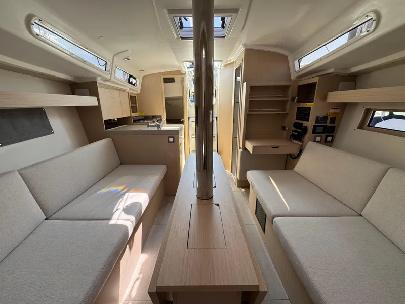 Slide: The Image of 2024 Beneteau Oceanis 34.1 interior with modern design, light wood finishes, and comfortable seating. - 14