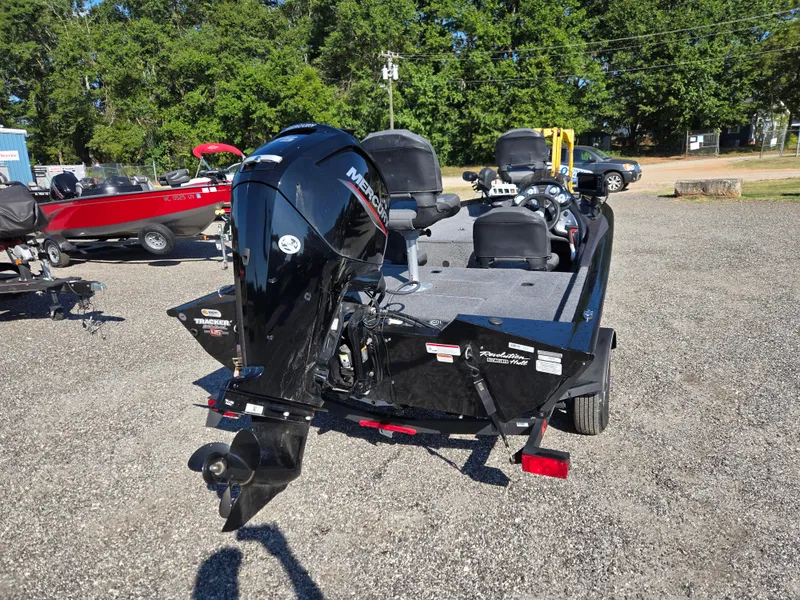 Slide: The Image of 2023 Tracker Pro Team 175 TF boat with Mercury outboard motor, parked outdoors. - 19