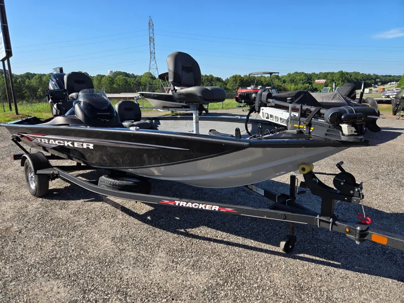 Slide: The Image of 2023 Tracker Pro Team 175 TF boat on trailer, parked outdoors. - 2