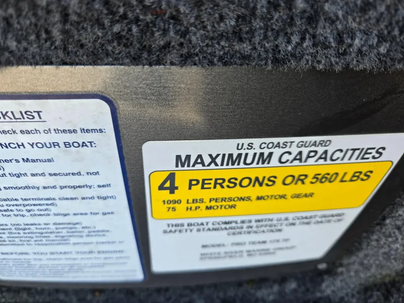 Slide: The Image of 2023 Tracker Pro Team 175 TF boat capacity label, maximum 4 persons or 560 lbs. - 4