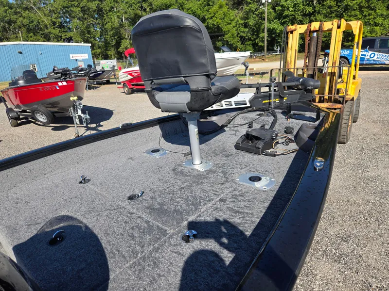 Slide: The Image of 2023 Tracker Pro Team 175 TF boat with seating and equipment on display outdoors. - 6