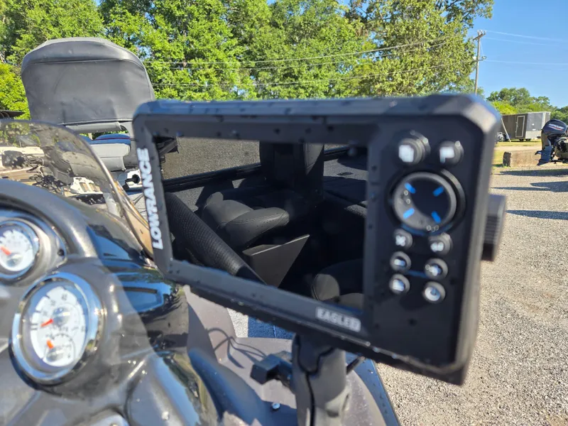 Slide: The Image of 2023 Tracker Pro Team 175 TF boat with Lowrance fish finder and gauges, outdoors. - 7