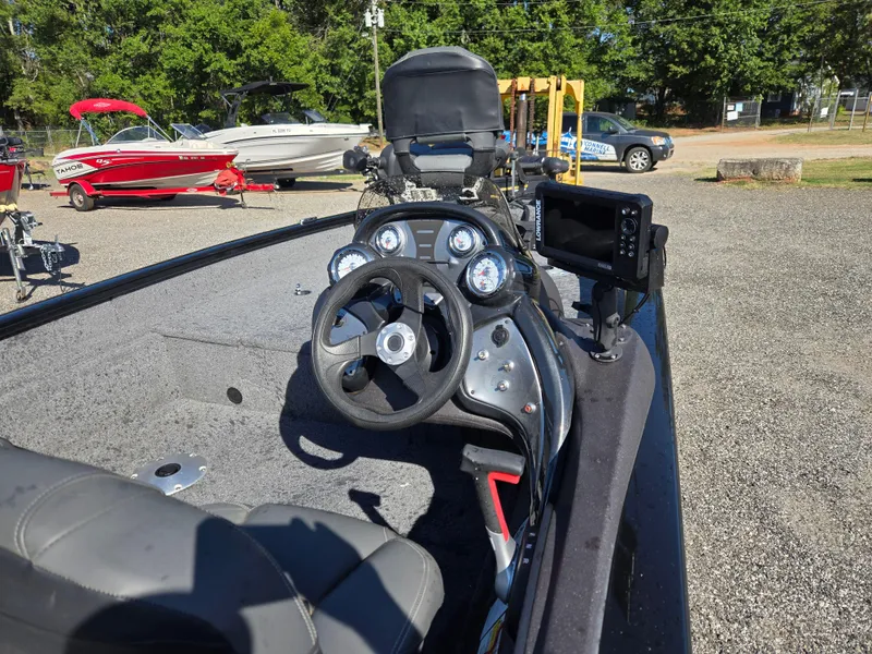 Slide: The Image of 2023 Tracker Pro Team 175 TF boat dashboard with steering wheel and electronic display. - 9