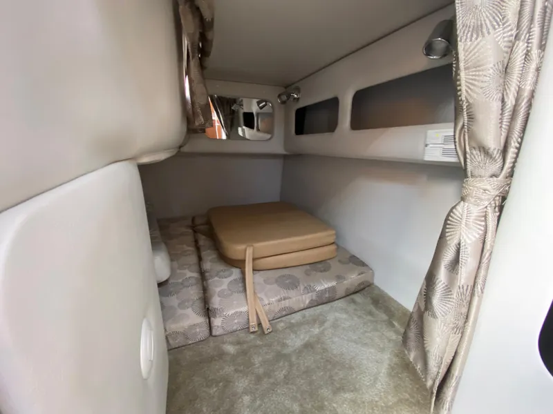 Slide: The Image of 2019 Crownline 264 CR cabin interior with cushions and curtains. - 14