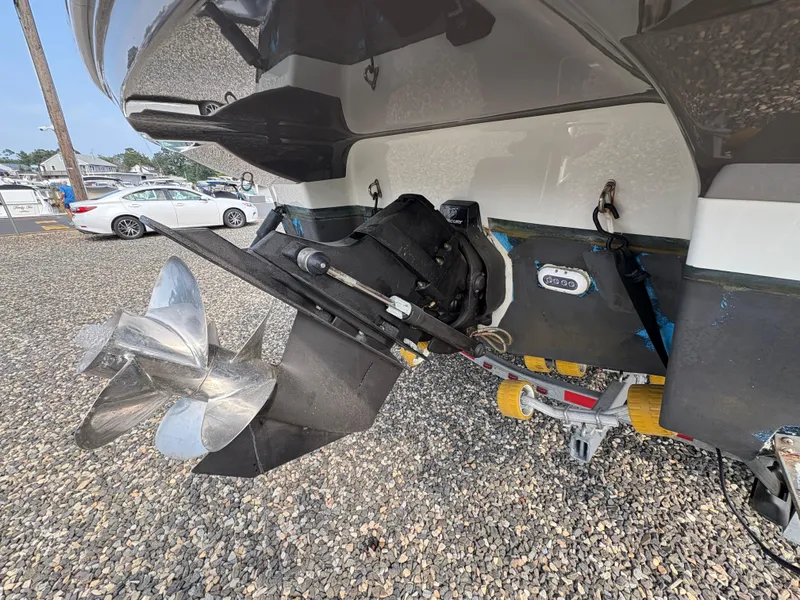 Slide: The Image of 2019 Crownline 264 CR boat propeller and stern drive on gravel surface. - 17