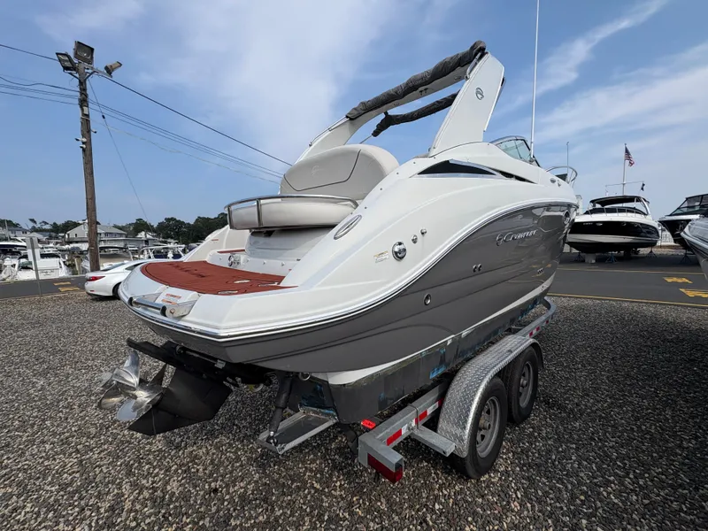 Slide: The Image of 2019 Crownline 264 CR boat on trailer, displayed in a marina setting. - 3