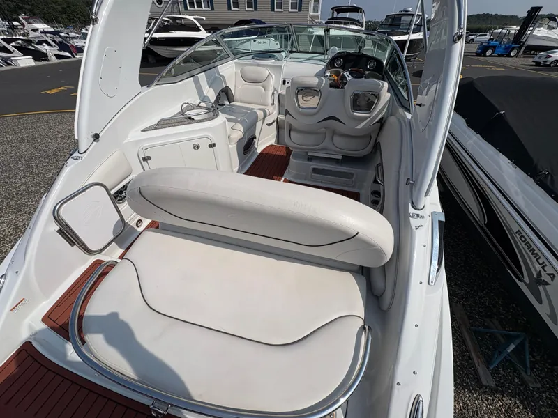 Slide: The Image of 2019 Crownline 264 CR boat interior with white seating and modern dashboard. - 6