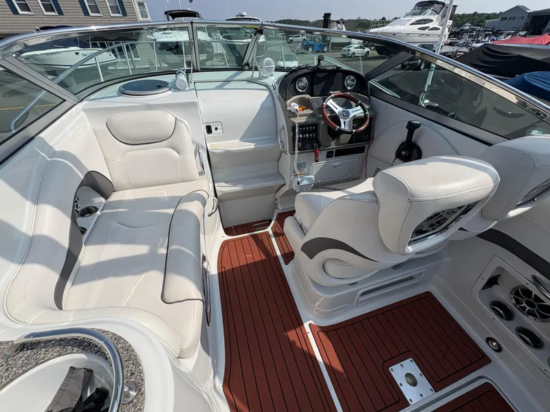 Slide: The Image of 2019 Crownline 264 CR boat interior with white seating and wood-style flooring. - 8