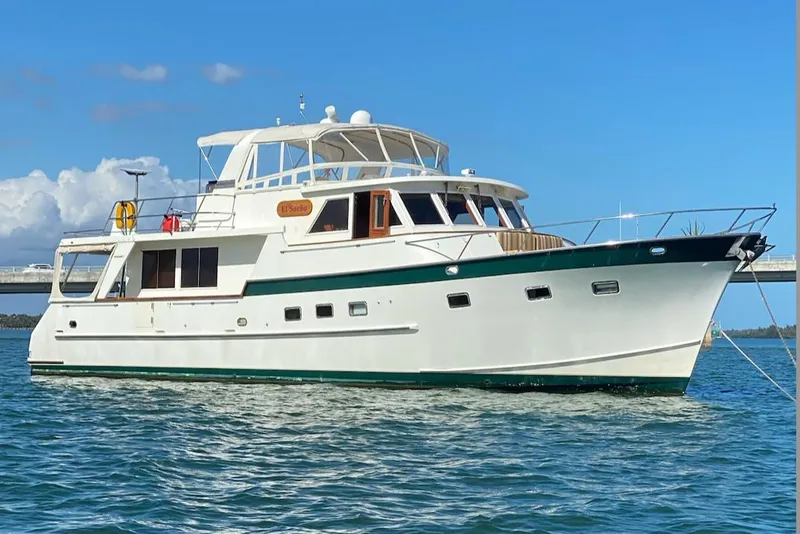 The Image of Grand Alaskan 60 Pilothouse yacht, 1998 model, anchored on calm blue waters. - 0