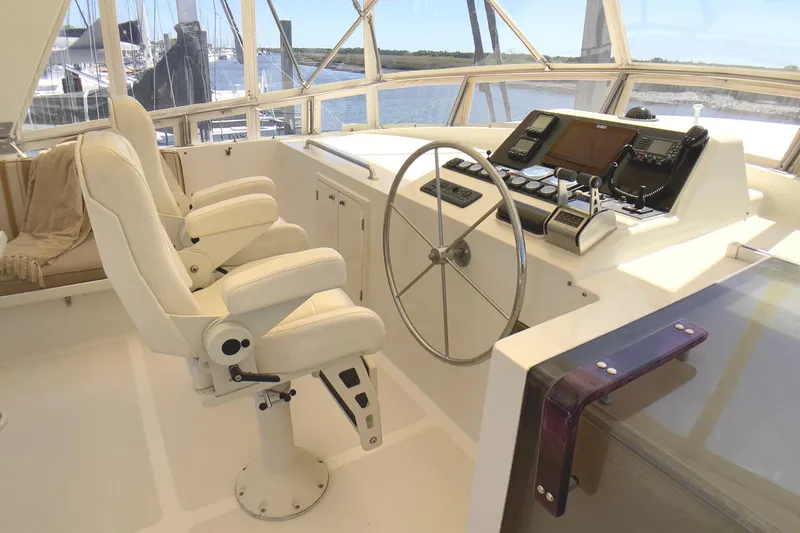 Slide: The Image of Pilothouse interior of 1998 Grand Alaskan 60, featuring dual captain chairs and navigation equipment. - 39