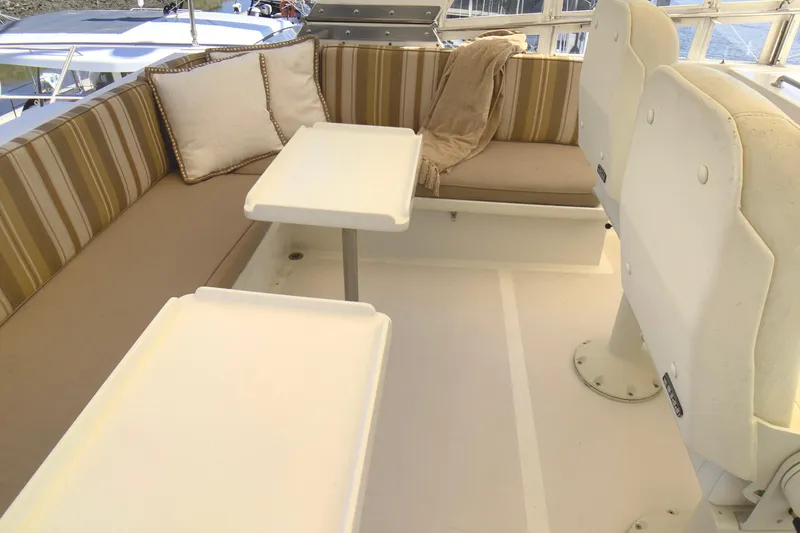 Slide: The Image of 1998 Grand Alaskan 60 Pilothouse interior with cushioned seating and tables. - 42