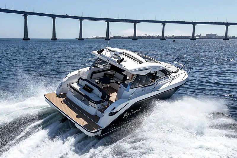 Slide: The Image of 2023 Bavaria SR36 yacht cruising under a bridge on open water. - 12