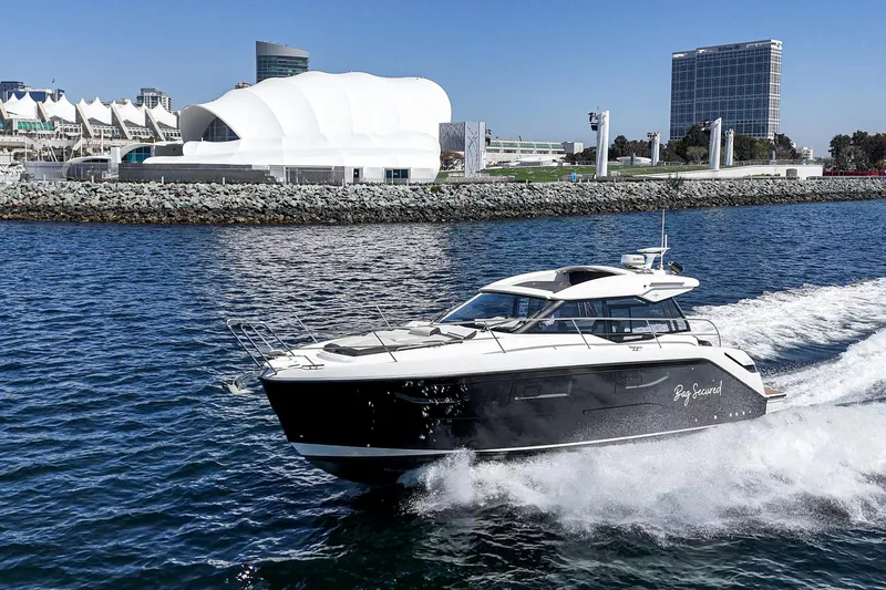 Slide: The Image of 2023 Bavaria SR36 yacht cruising near modern waterfront buildings. - 15