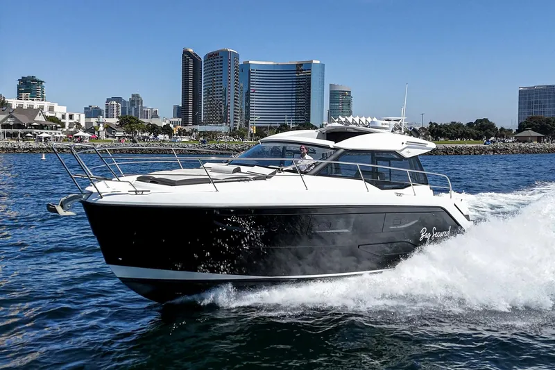 Slide: The Image of 2023 Bavaria SR36 yacht cruising in urban waterfront setting. - 2