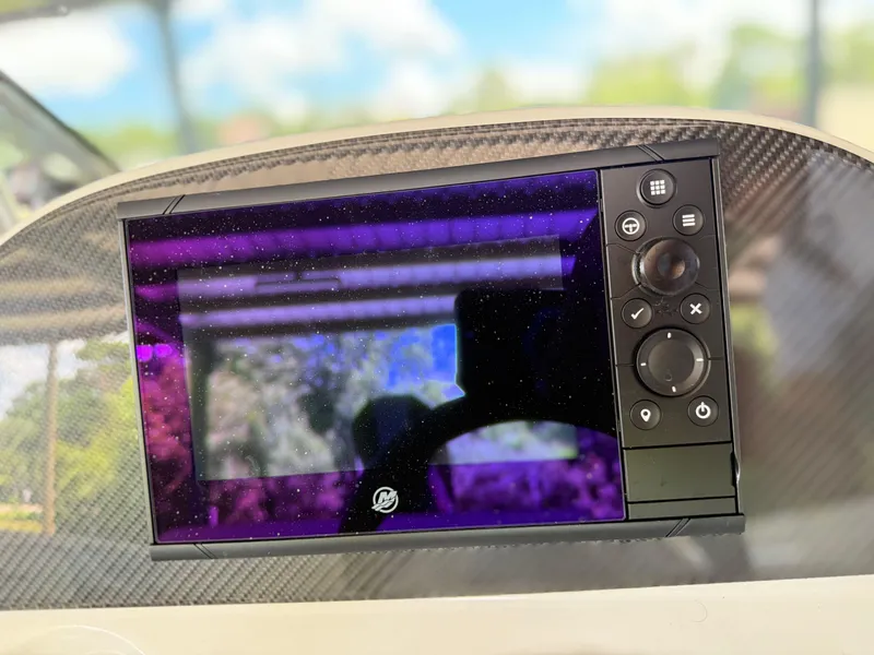 Slide: The Image of Dashboard display of 2024 Checkmate Pulsare 2400 BRX boat with control buttons. - 13