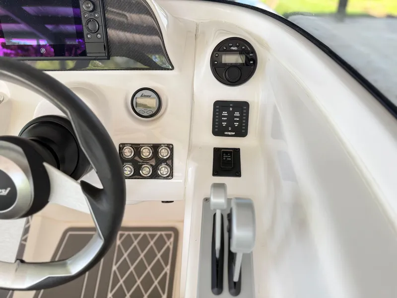 Slide: The Image of 2024 Checkmate Pulsare 2400 BRX dashboard with steering wheel, controls, and digital display. - 14