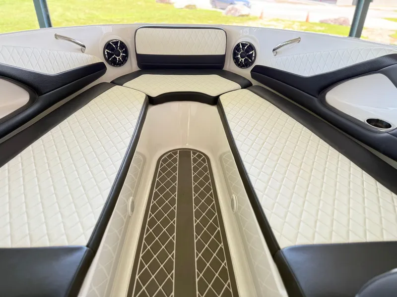 Slide: The Image of 2024 Checkmate Pulsare 2400 BRX boat interior with diamond-stitched seating and sleek design. - 16