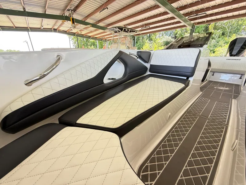 Slide: The Image of 2024 Checkmate Pulsare 2400 BRX boat interior with luxurious quilted seating under a canopy. - 19