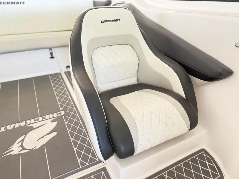 Slide: The Image of 2024 Checkmate Pulsare 2400 BRX boat seat with diamond-stitched upholstery and branded flooring. - 21