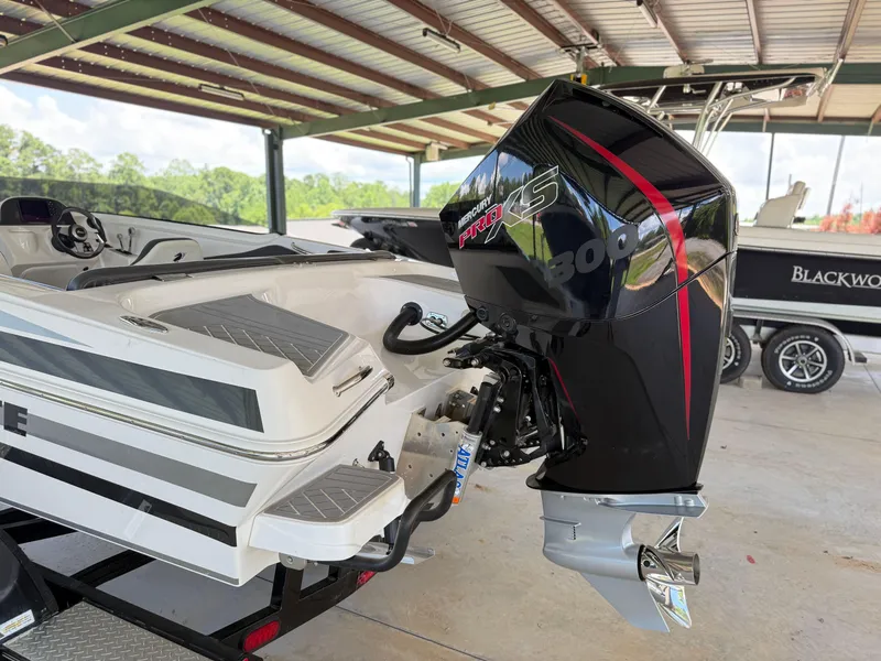 Slide: The Image of 2024 Checkmate Pulsare 2400 BRX boat with Mercury Pro XS 300 engine in a covered area. - 26