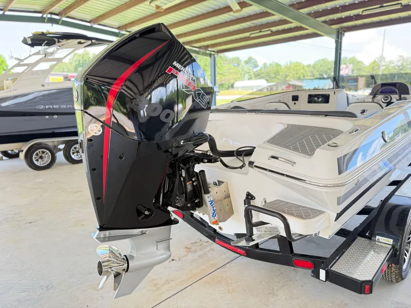 Slide: The Image of 2024 Checkmate Pulsare 2400 BRX boat with Mercury Pro XS engine in a covered area. - 7