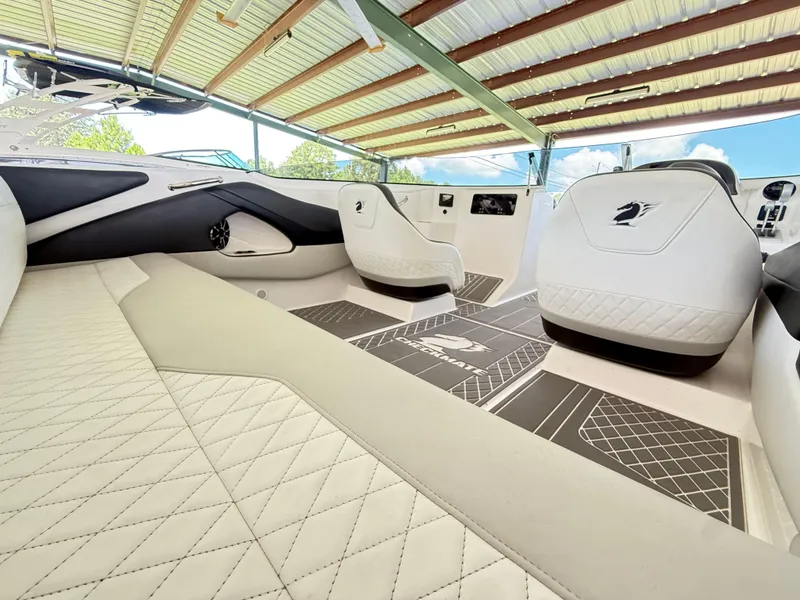 Slide: The Image of 2024 Checkmate Pulsare 2400 BRX interior with luxurious seating and modern design under a canopy. - 8