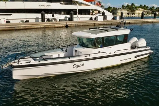 The Image of 2023 Axopar 28 CABIN boat docked in a marina, side view. - 0