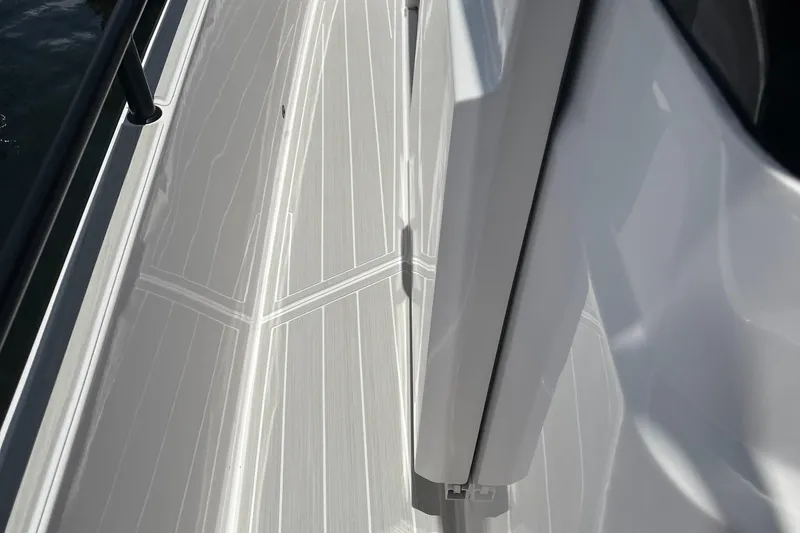 Slide: The Image of 2023 Axopar 28 CABIN boat deck with sleek, modern design details. - 14