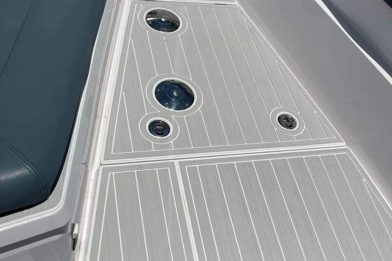 Slide: The Image of 2023 Axopar 28 CABIN deck with sleek design and integrated fixtures. - 9