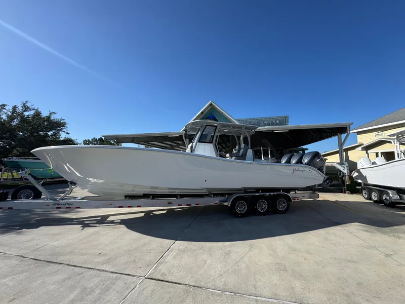 The Image of 2026 Yellowfin 36 Offshore boat on trailer under clear blue sky. - 1