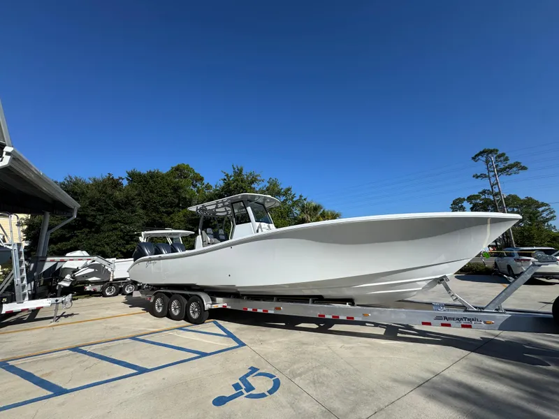 Slide: The Image of 2026 Yellowfin 36 Offshore boat on trailer under clear blue sky. - 10