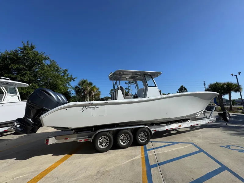 Slide: The Image of 2026 Yellowfin 36 Offshore boat on trailer under clear blue sky. - 12
