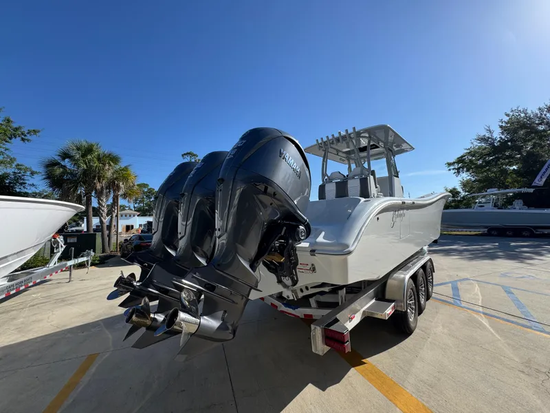 Slide: The Image of 2026 Yellowfin 36 Offshore boat with triple Yamaha outboard engines on a trailer. - 13