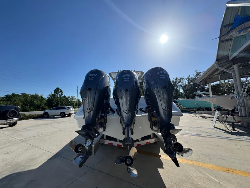 Slide: The Image of 2026 Yellowfin 36 Offshore boat with triple 350 V8 engines in a sunny marina. - 15