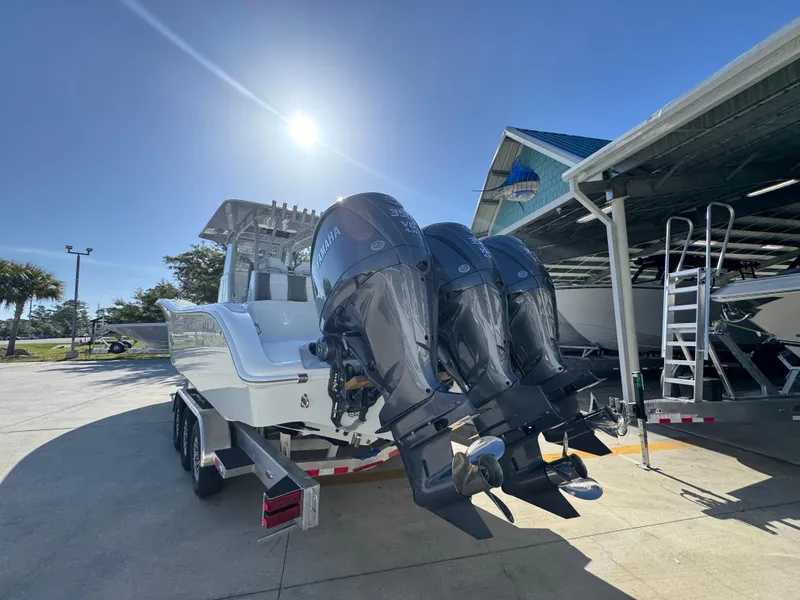 Slide: The Image of 2026 Yellowfin 36 Offshore boat with triple Yamaha outboard engines in a sunny marina. - 16