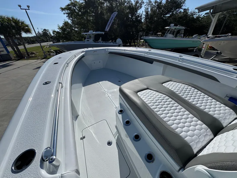 Slide: The Image of 2026 Yellowfin 36 Offshore boat interior with cushioned seating and sleek design. - 21