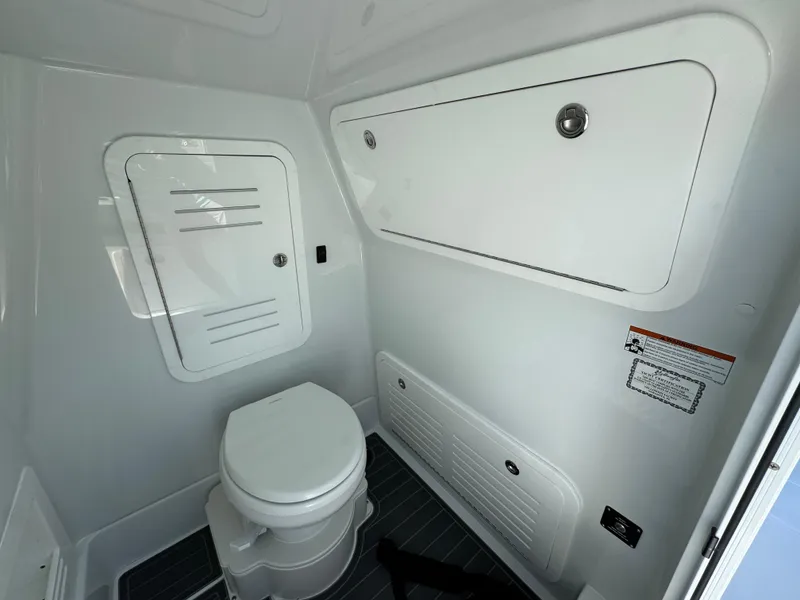 Slide: The Image of 2026 Yellowfin 36 Offshore boat interior bathroom with white fixtures and storage compartments. - 31