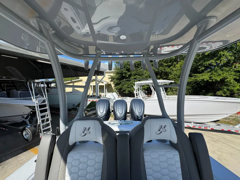 Slide: The Image of 2026 Yellowfin 36 Offshore boat interior with triple engines and seating. - 34