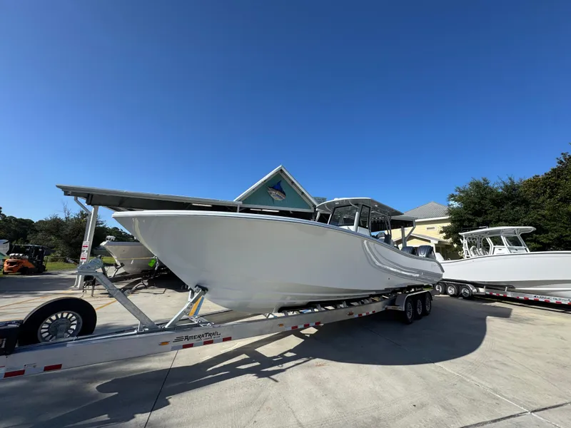 Slide: The Image of 2026 Yellowfin 36 Offshore boat on trailer under clear blue sky. - 4