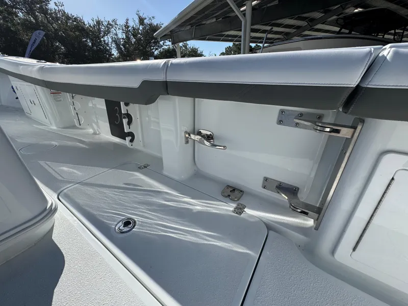 Slide: The Image of 2026 Yellowfin 36 Offshore boat interior with sleek white seating and stainless steel fixtures. - 41