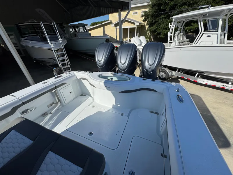 Slide: The Image of 2026 Yellowfin 36 Offshore boat with triple outboard engines in a showroom. - 42