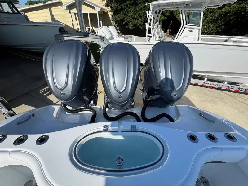 Slide: The Image of 2026 Yellowfin 36 Offshore boat with triple outboard engines, docked in a marina. - 44