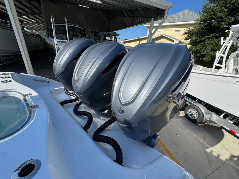 Slide: The Image of Triple outboard engines on a 2026 Yellowfin 36 Offshore boat in a marina. - 45