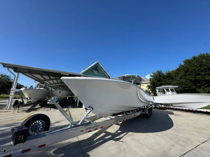 Slide: The Image of 2026 Yellowfin 36 Offshore boat on trailer under clear blue sky. - 5
