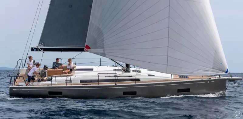 Slide: The Image of 2024 Beneteau First 44 sailing yacht on open water with crew onboard. - 0